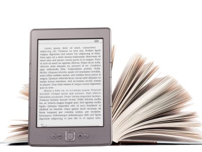 Electronic book reader with LOREM IPSUM text and thick paper book over white background